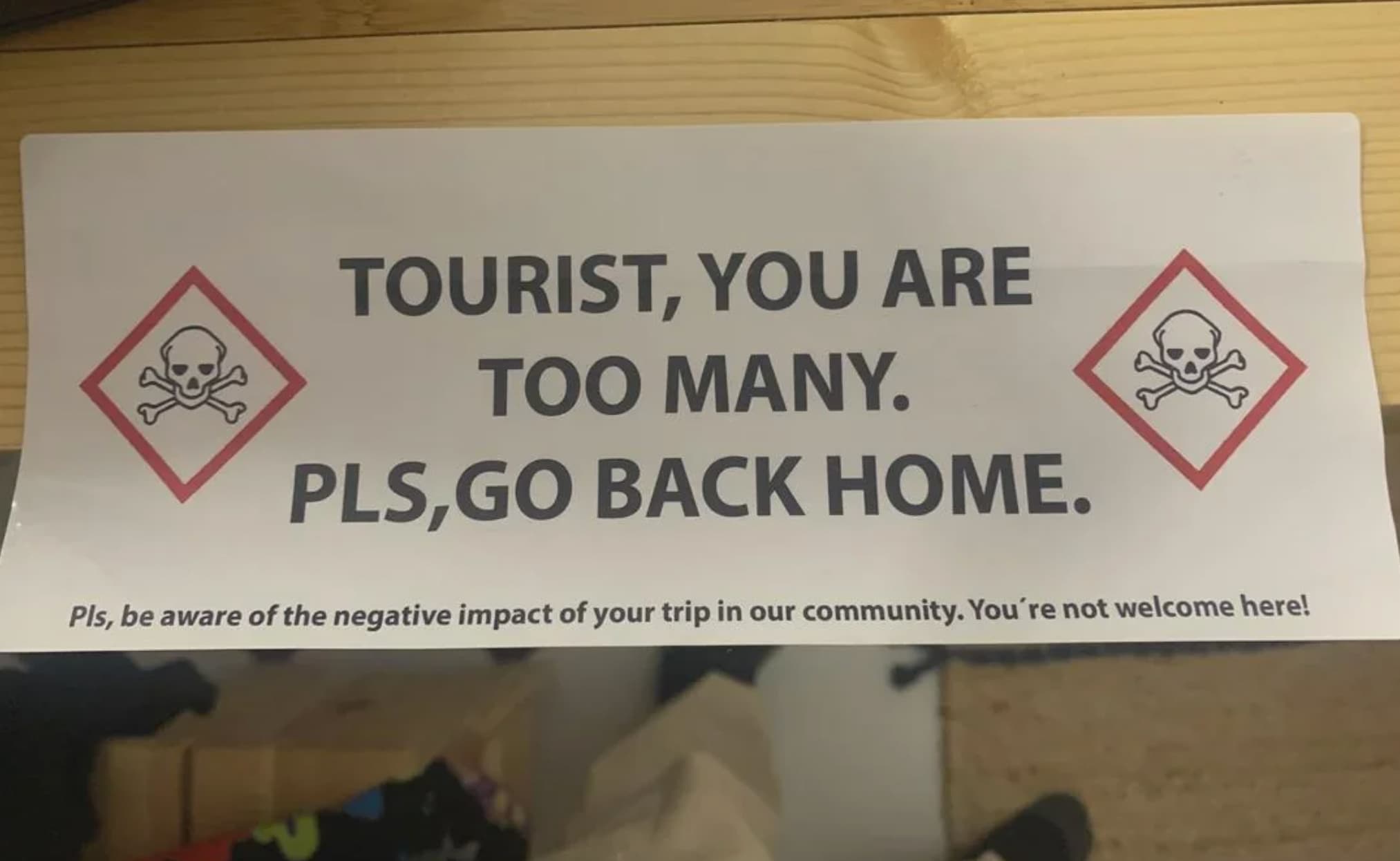 signage - Tourist, You Are Too Many. Pls,Go Back Home. Pls, be aware of the negative impact of your trip in our community. You're not welcome here!